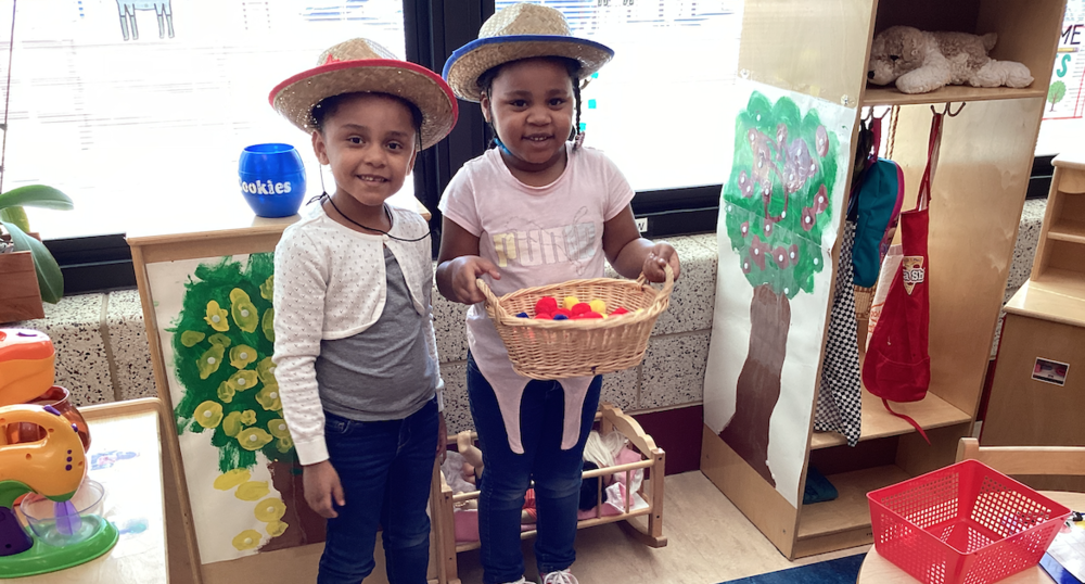Students harvesting apples in dramatic play