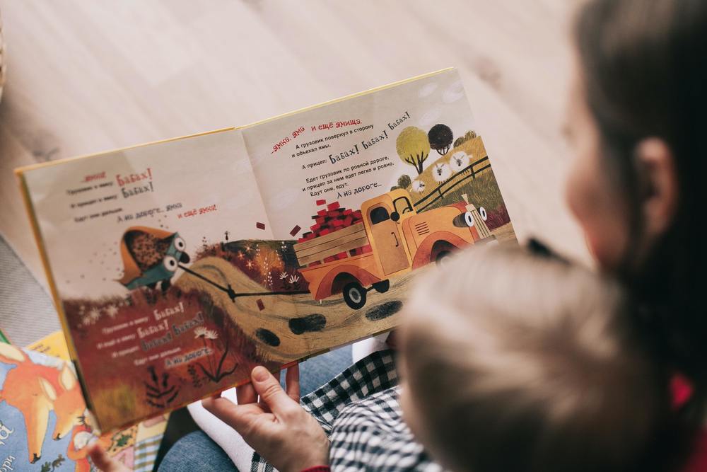 woman and child looking at a picture book