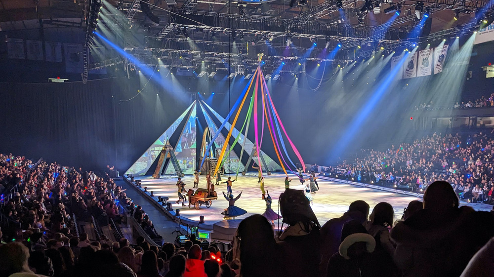 performers on the ice under rainbow streamers